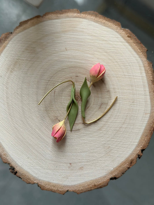Close-up of handmade tulip earrings in polymer clay – soft pink petals with stainless steel hooks