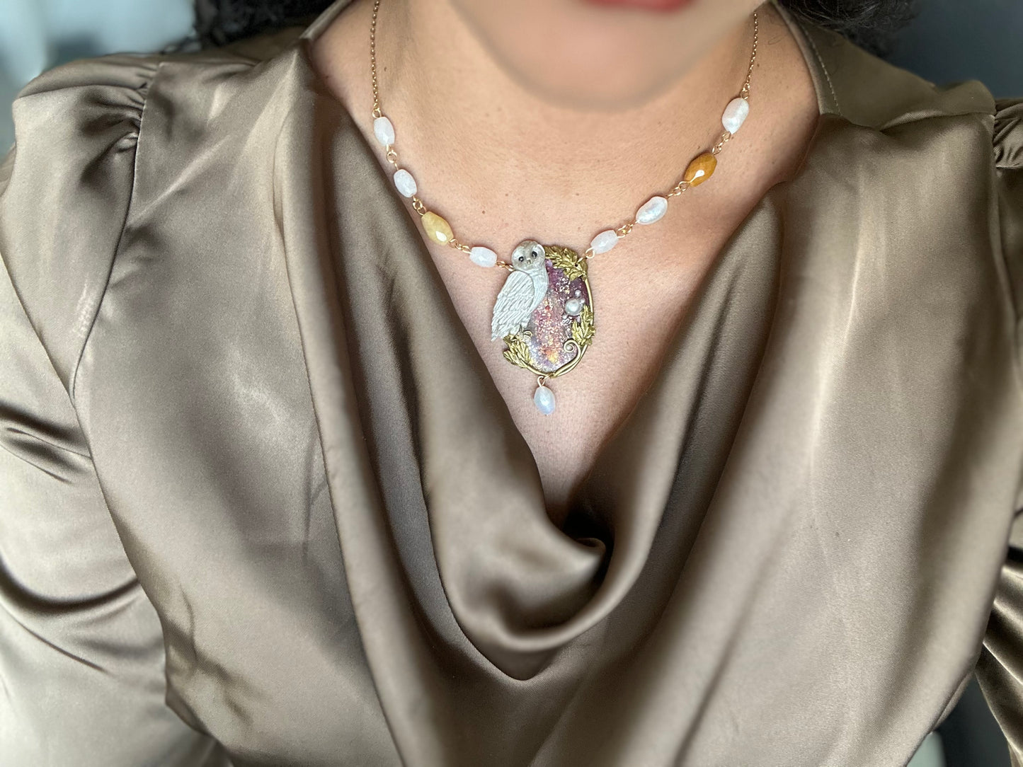 Hand-sculpted owl pendant necklace with freshwater pearls and shimmering gold accents.