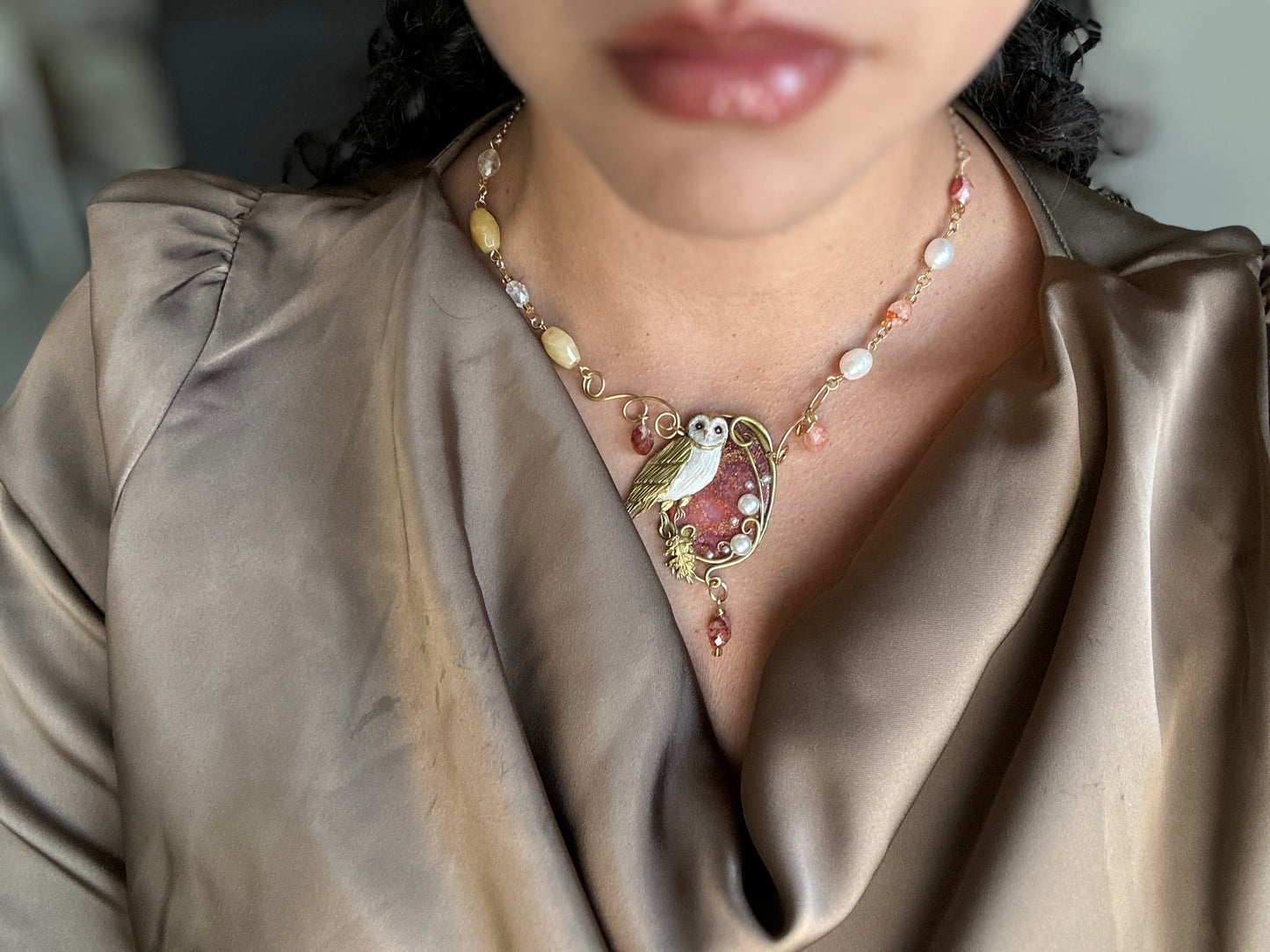 One-of-a-kind handmade necklace with owl motif, freshwater pearls, quartz, and gold accents.