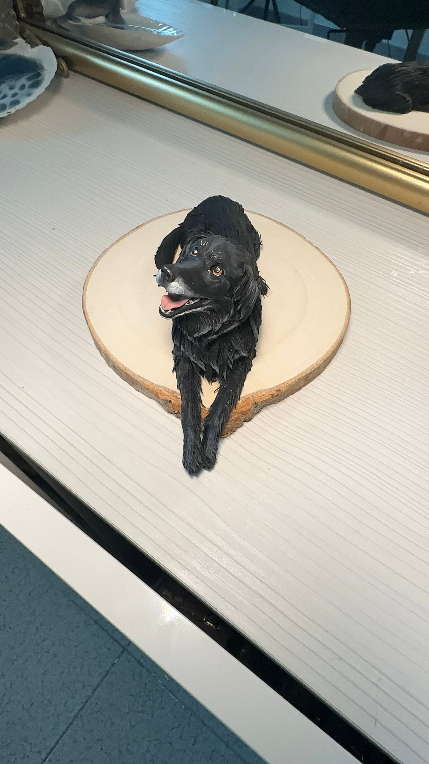 Handmade memorial sculpture of a dog named Dodò, crafted in polymer clay, mounted on a round wooden base with an engraved name plaque. Realistic details capture the pet’s unique expression.