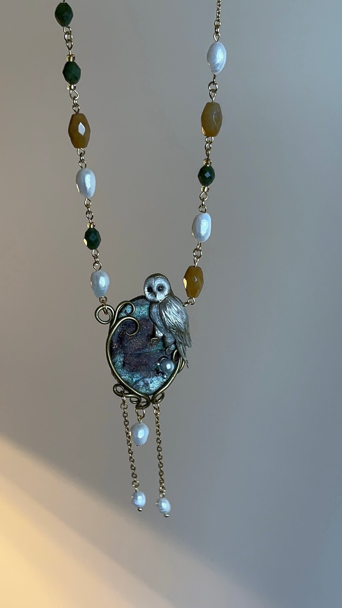 Luxury artisan necklace with owl pendant, freshwater pearls, and faceted agates, perfect for elegant outfits.