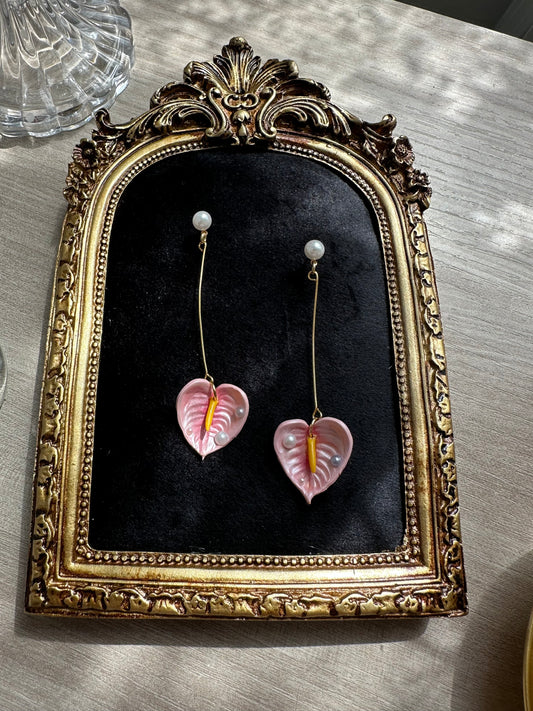 Handmade floral earrings with pink anthurium and pearl drops, long gold structure in stainless steel – inspired by tropical nature.”