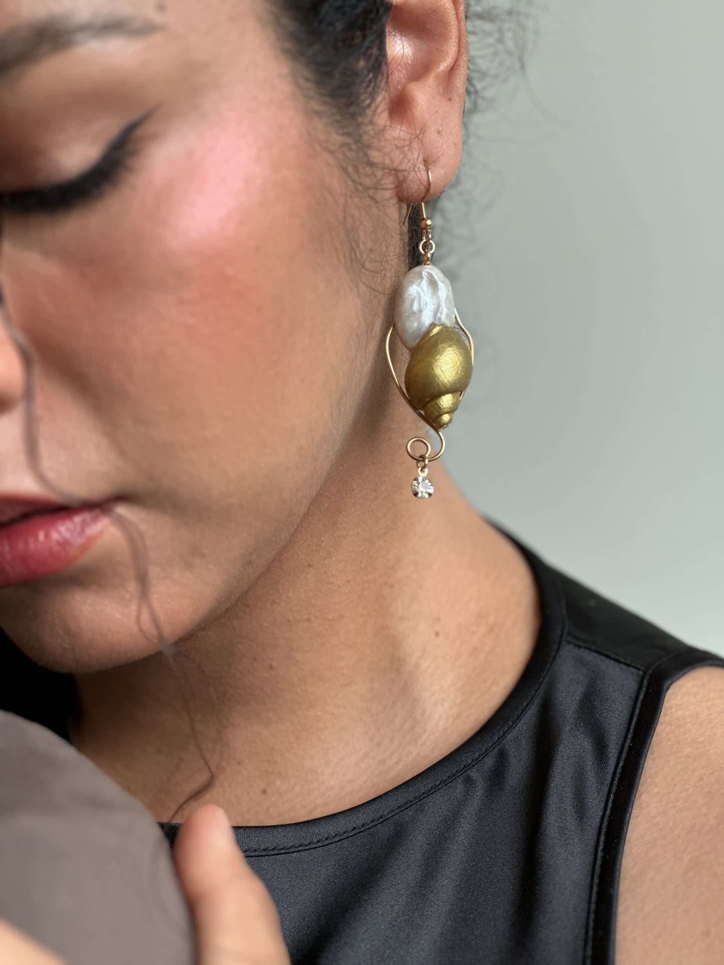 Close-up of handmade sea-creature statement earrings on a black outfit, made for anyone who wants summer jewelry that doesn’t look like everyone else’s beach accessories.