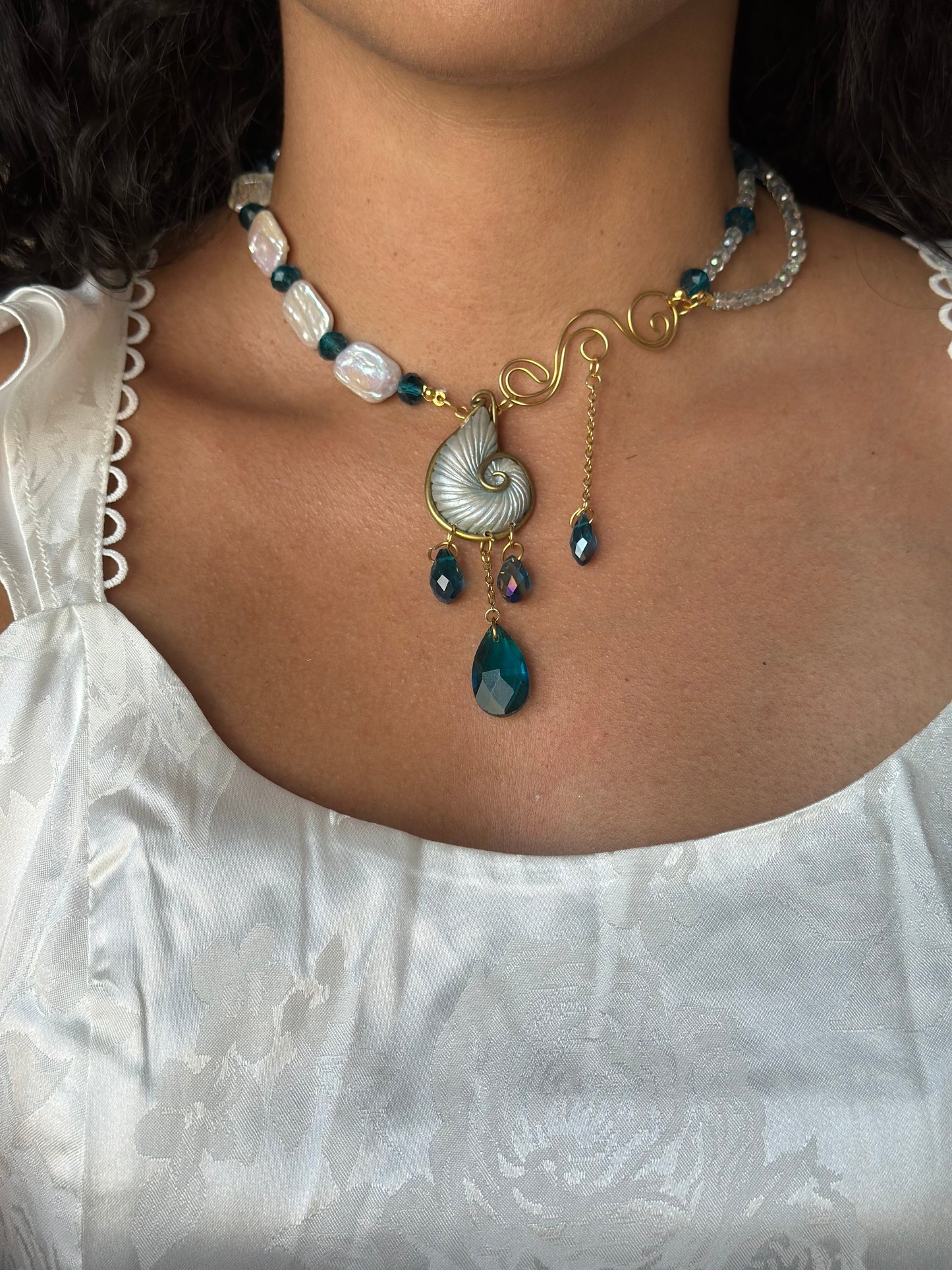 High-end ocean-themed necklace with gold and pearl details, perfect for luxury fashion styling.