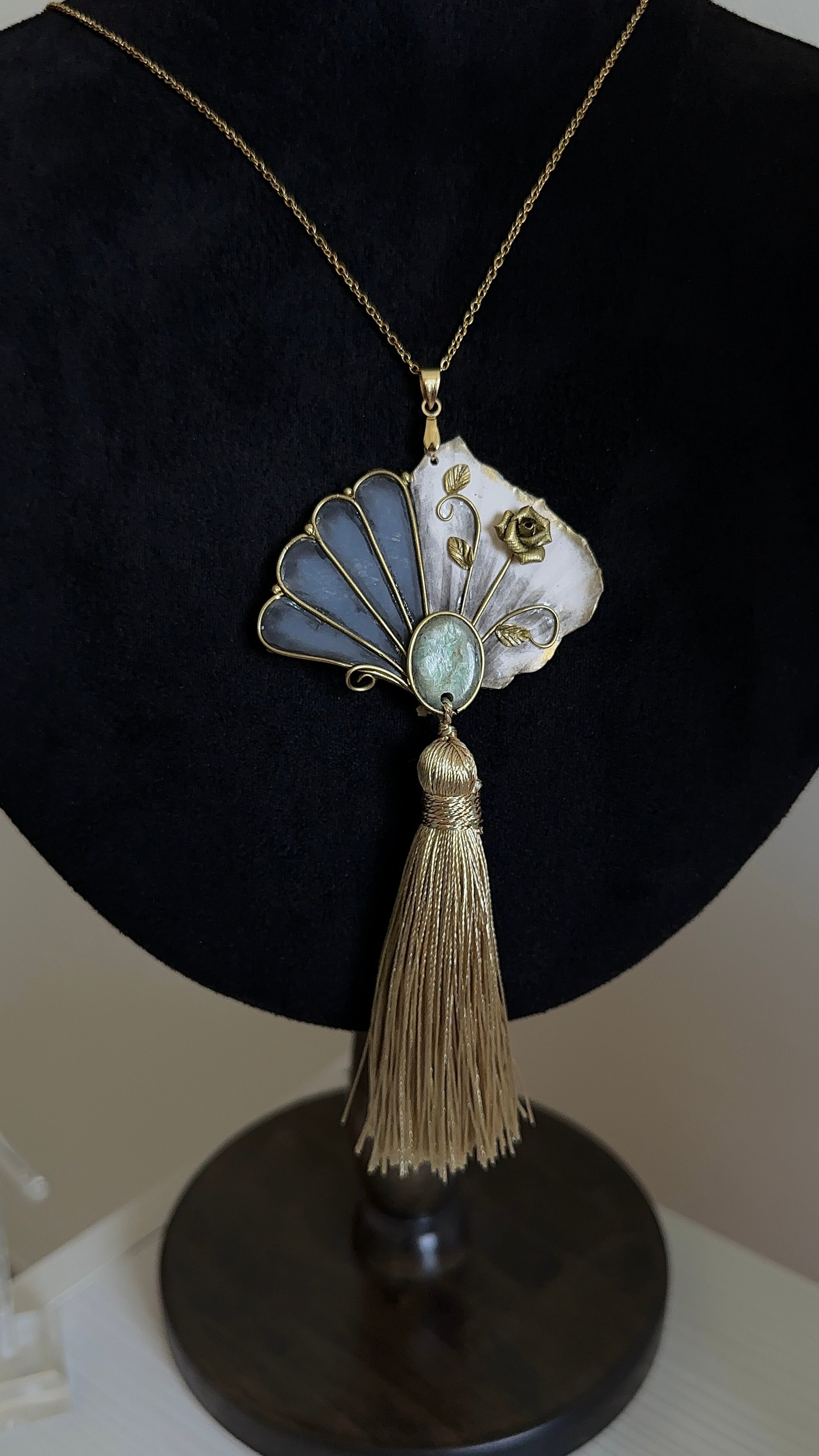 1. Handmade wearable relic tassel necklace with sculptural fan pendant, green stone detail and golden vintage-inspired finish for elegant unusual outfits.