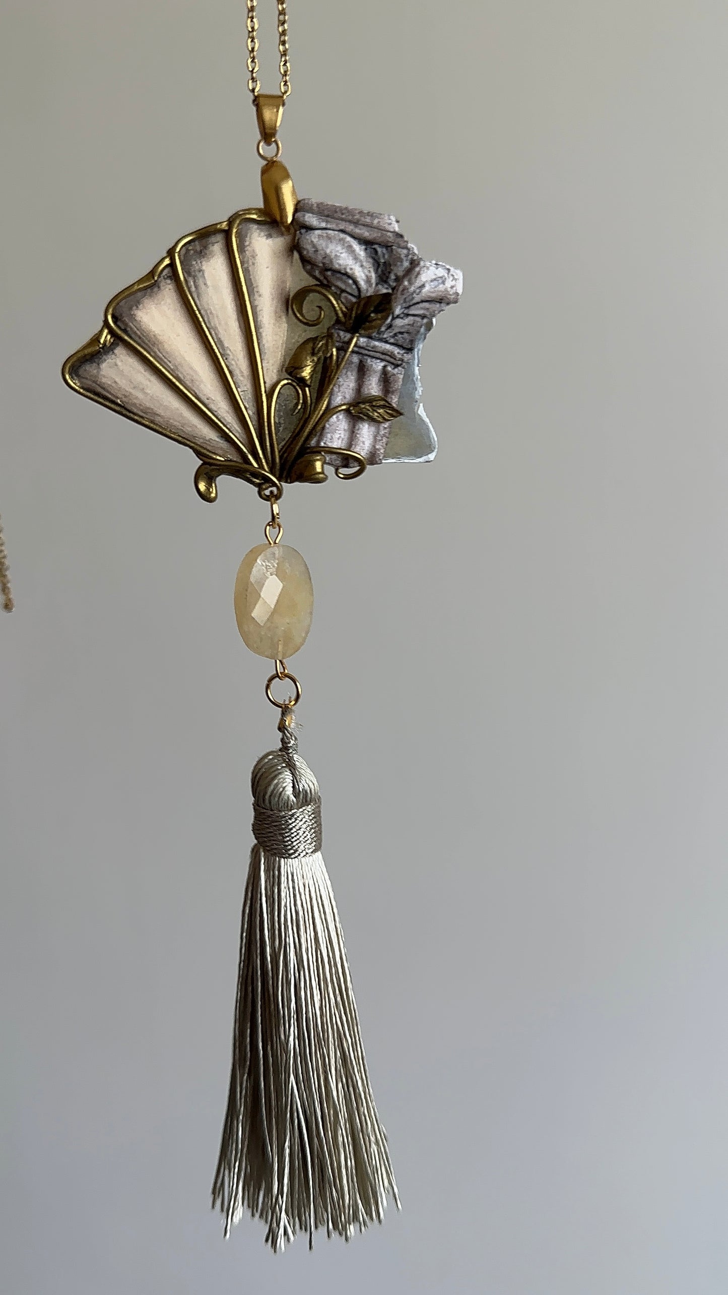     Sculptural palazzo-inspired necklace with fan-shaped pendant, antique tones and thread tassel, distinctive jewelry for women who love rare accessories