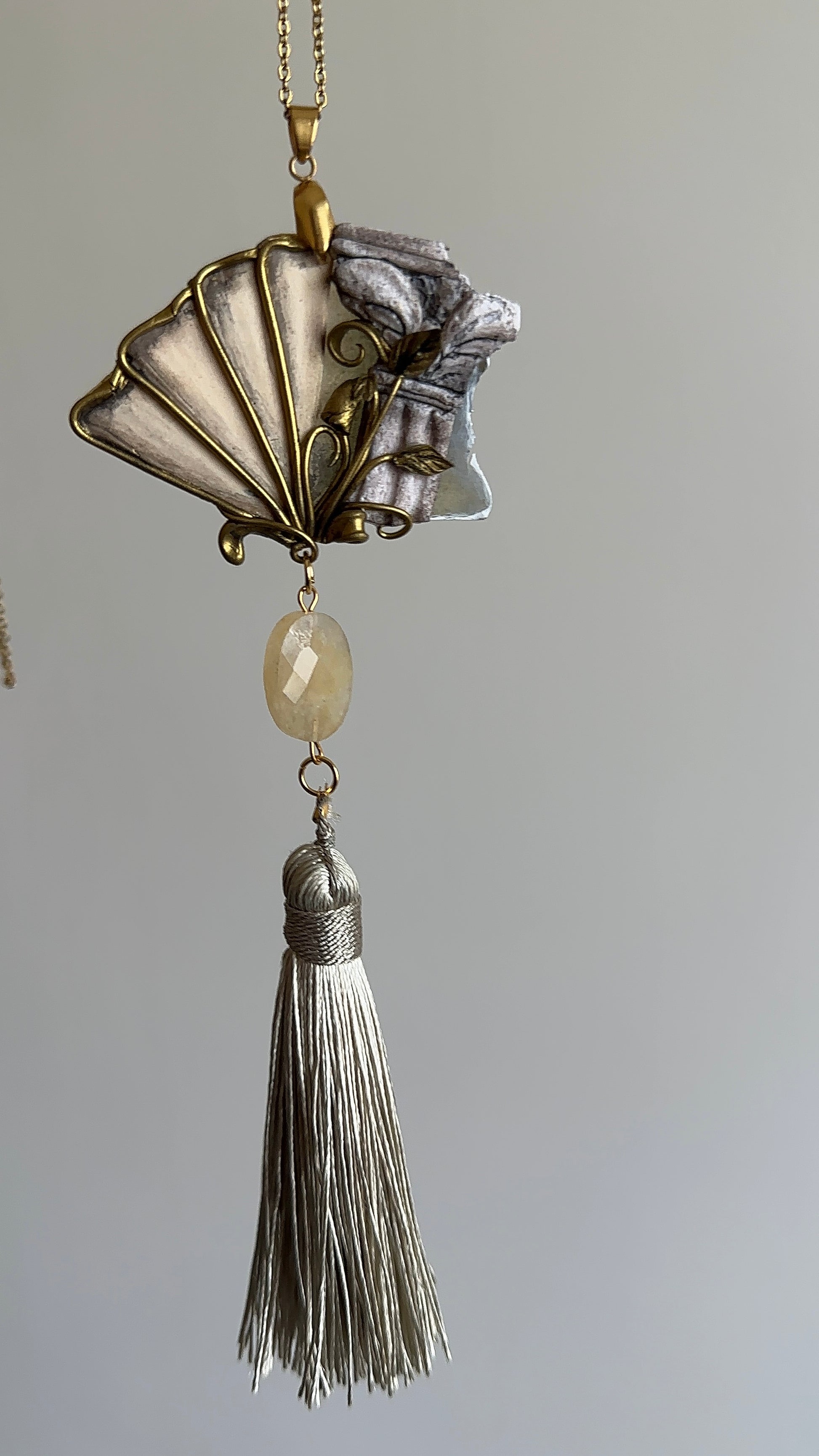     Sculptural palazzo-inspired necklace with fan-shaped pendant, antique tones and thread tassel, distinctive jewelry for women who love rare accessories