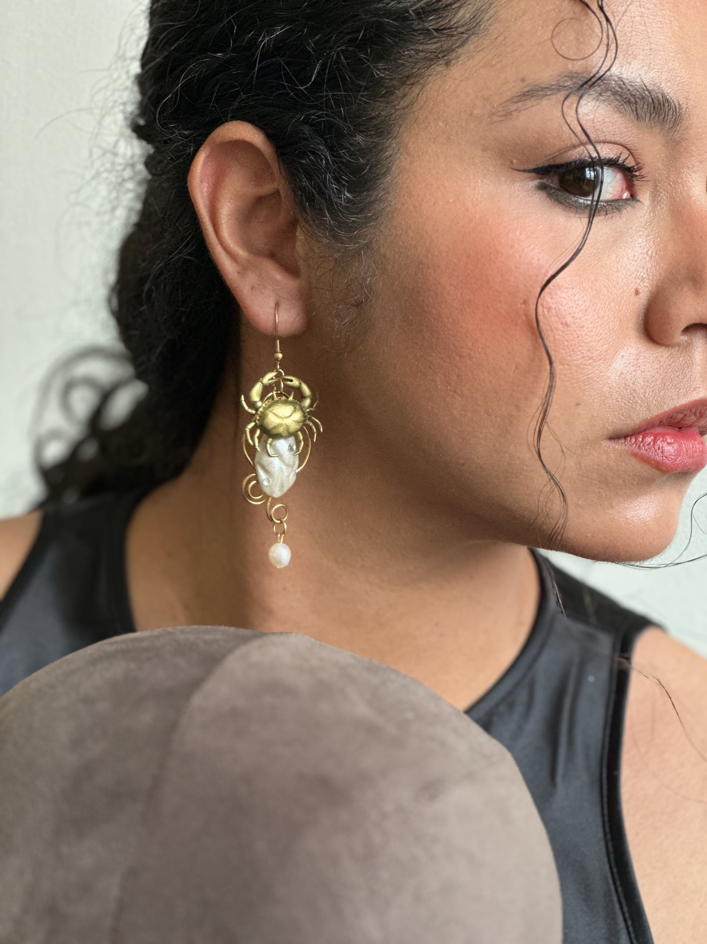     One-of-a-kind handmade earrings inspired by crabs, shells and sea treasures, styled to make a simple black dress feel less predictable and more personal.