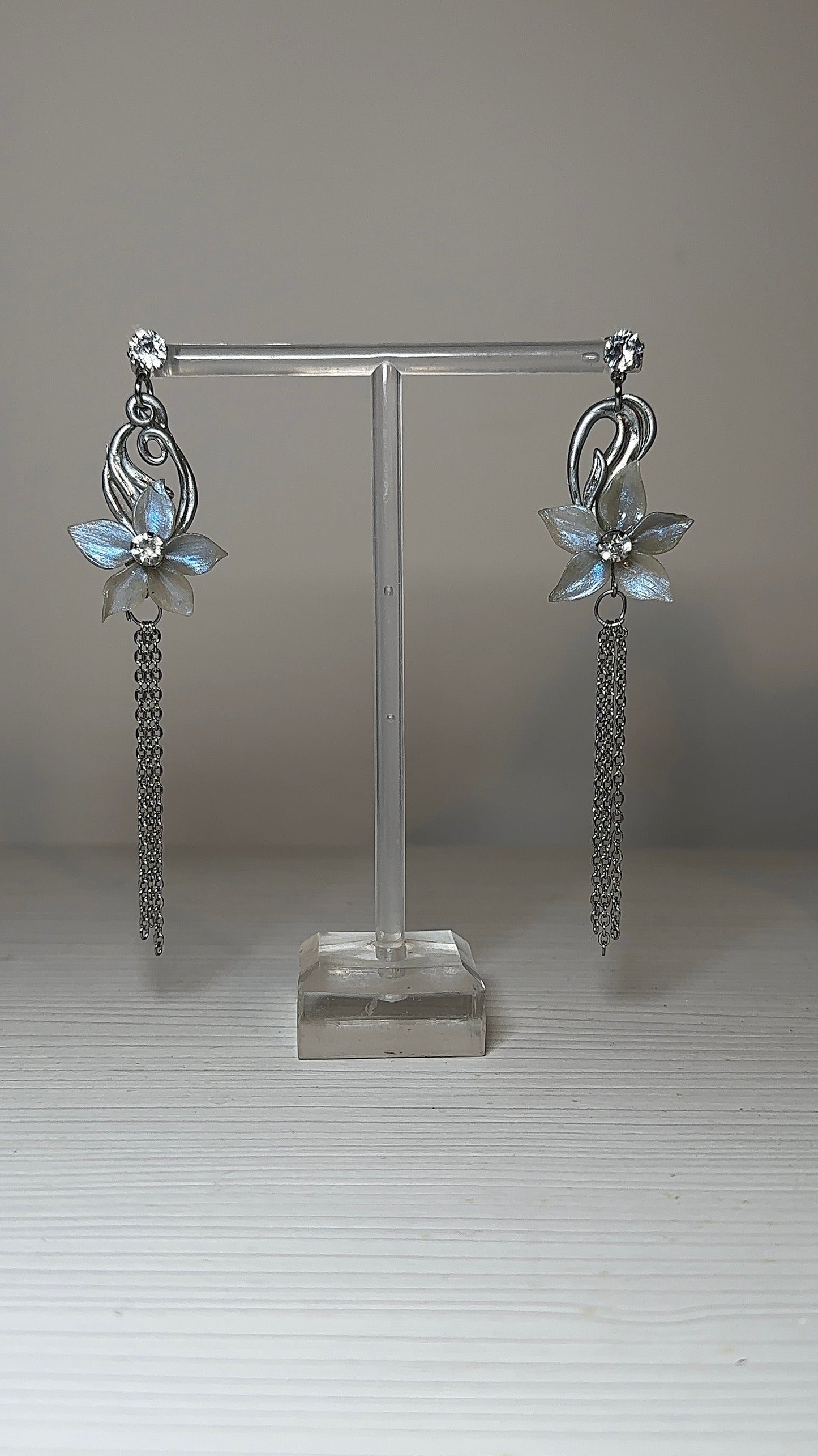 Art Nouveau inspired floral earrings featuring soft icy tones, sculpted petals, and subtle crystal details, designed as romantic statement jewellery.