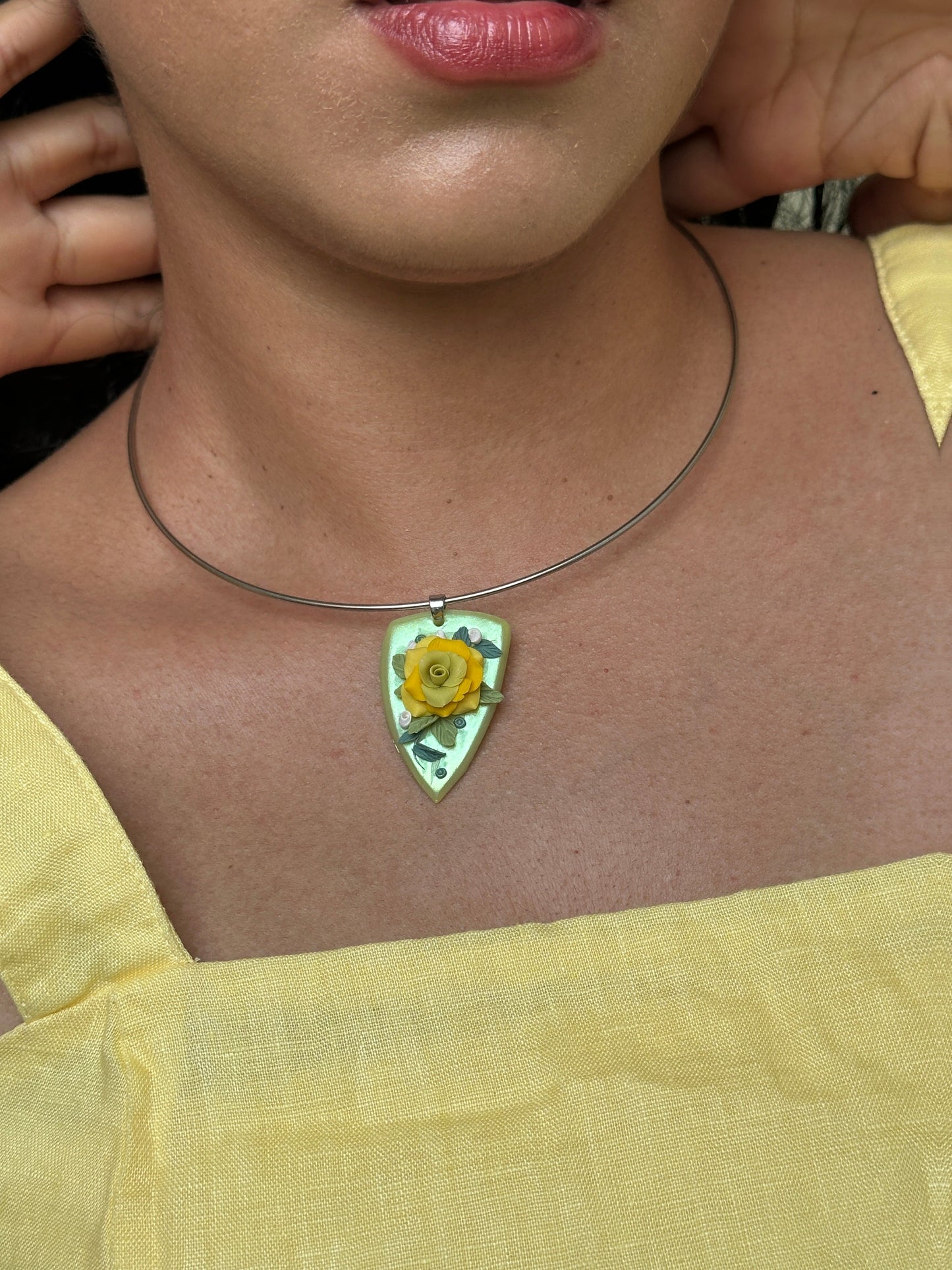     Yellow rose floral statement necklace with handmade botanical details and stainless steel choker collar, worn with a simple summer dress.
