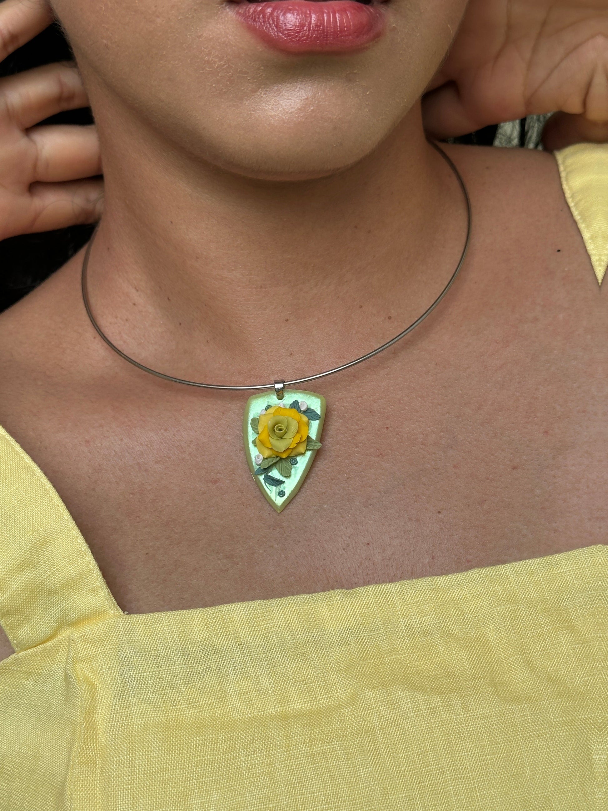     Yellow rose floral statement necklace with handmade botanical details and stainless steel choker collar, worn with a simple summer dress.