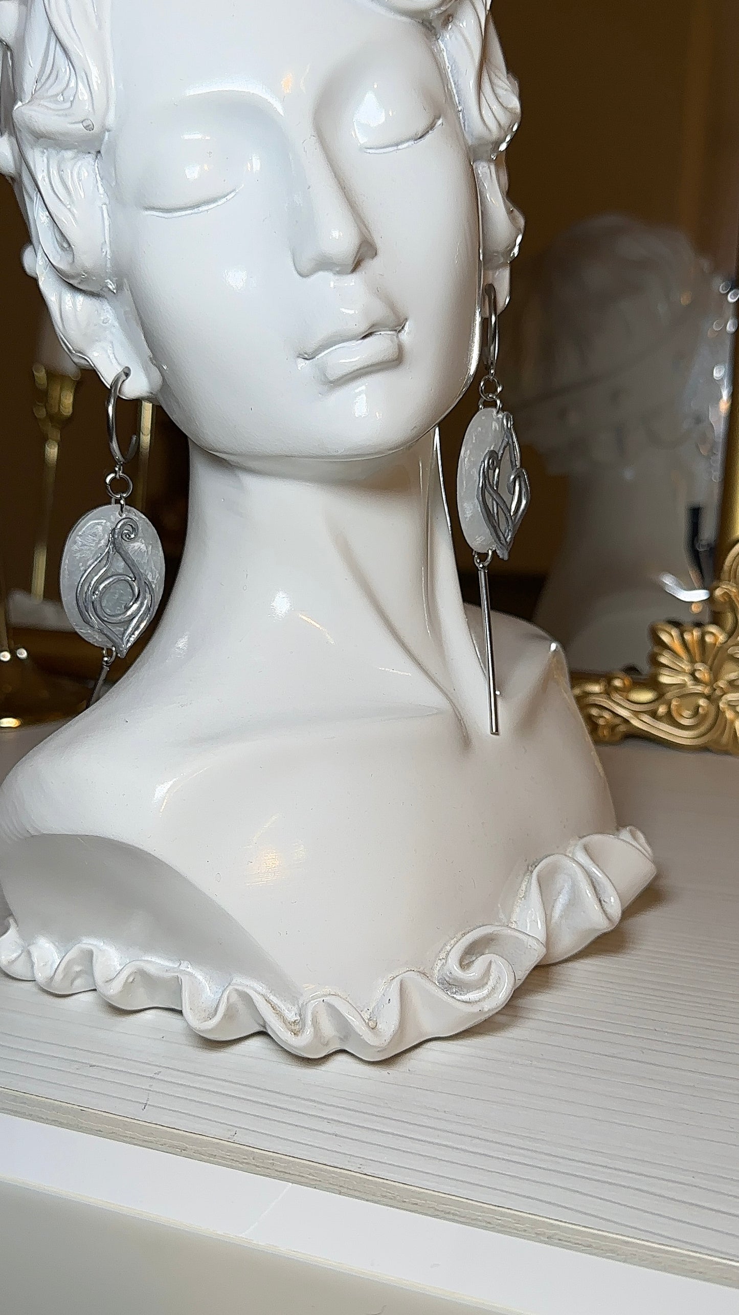 Long silver statement earrings with translucent icy oval pendant and sculptural Art Nouveau curves, elegant minimalist jewelry for refined outfits