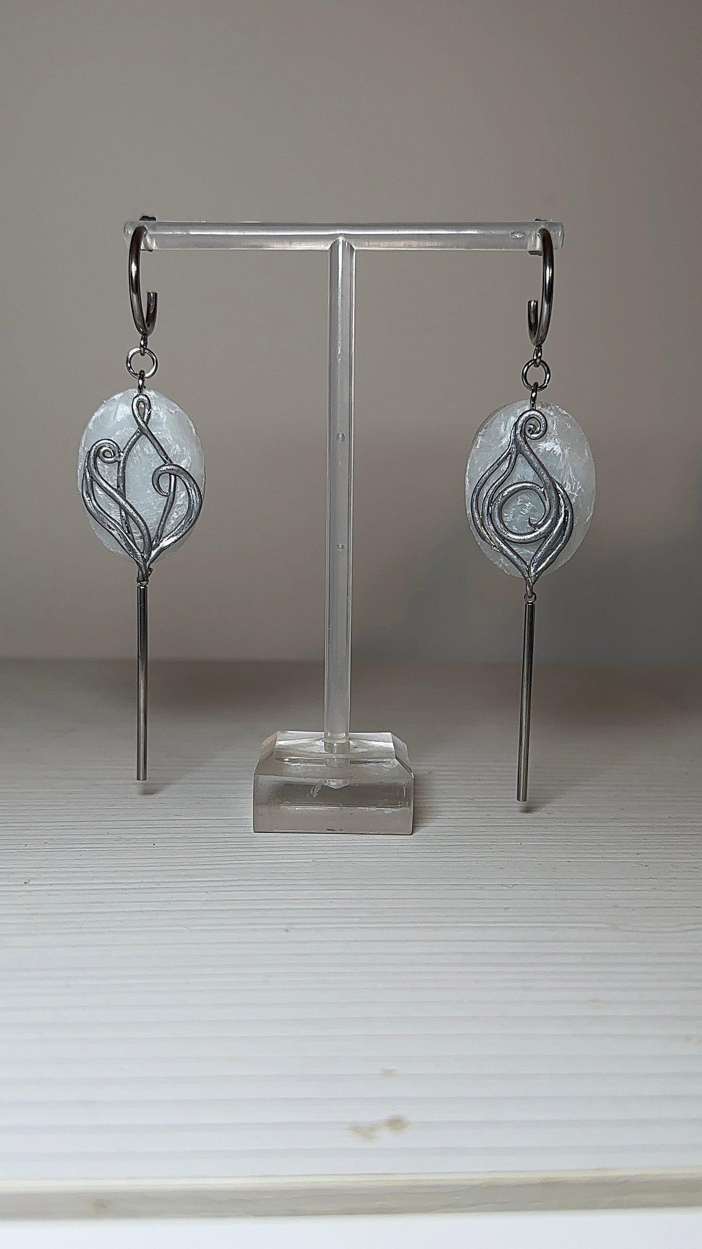 Elegant silver drop earrings with frosted ice-like texture and flowing organic lines, modern artisan jewelry for sophisticated women