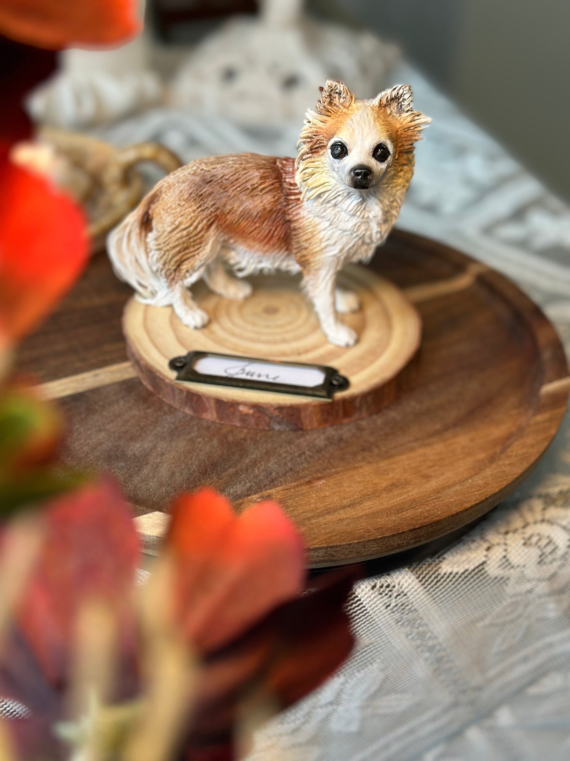 Luxury hand-crafted dog sculpture resting on a natural wood base, capturing a beloved pet’s gentle expression and presence. Elegant home setting with warm tones, perfect for sentimental collectors who want to keep love close.