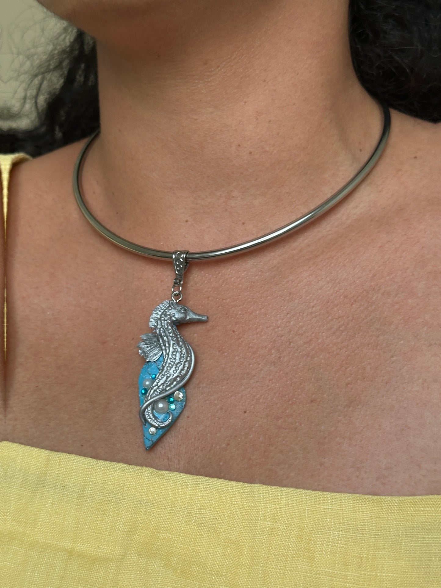     Sculptural seahorse statement necklace with faux turquoise base, designed for women who collect unusual ocean inspired jewelry.