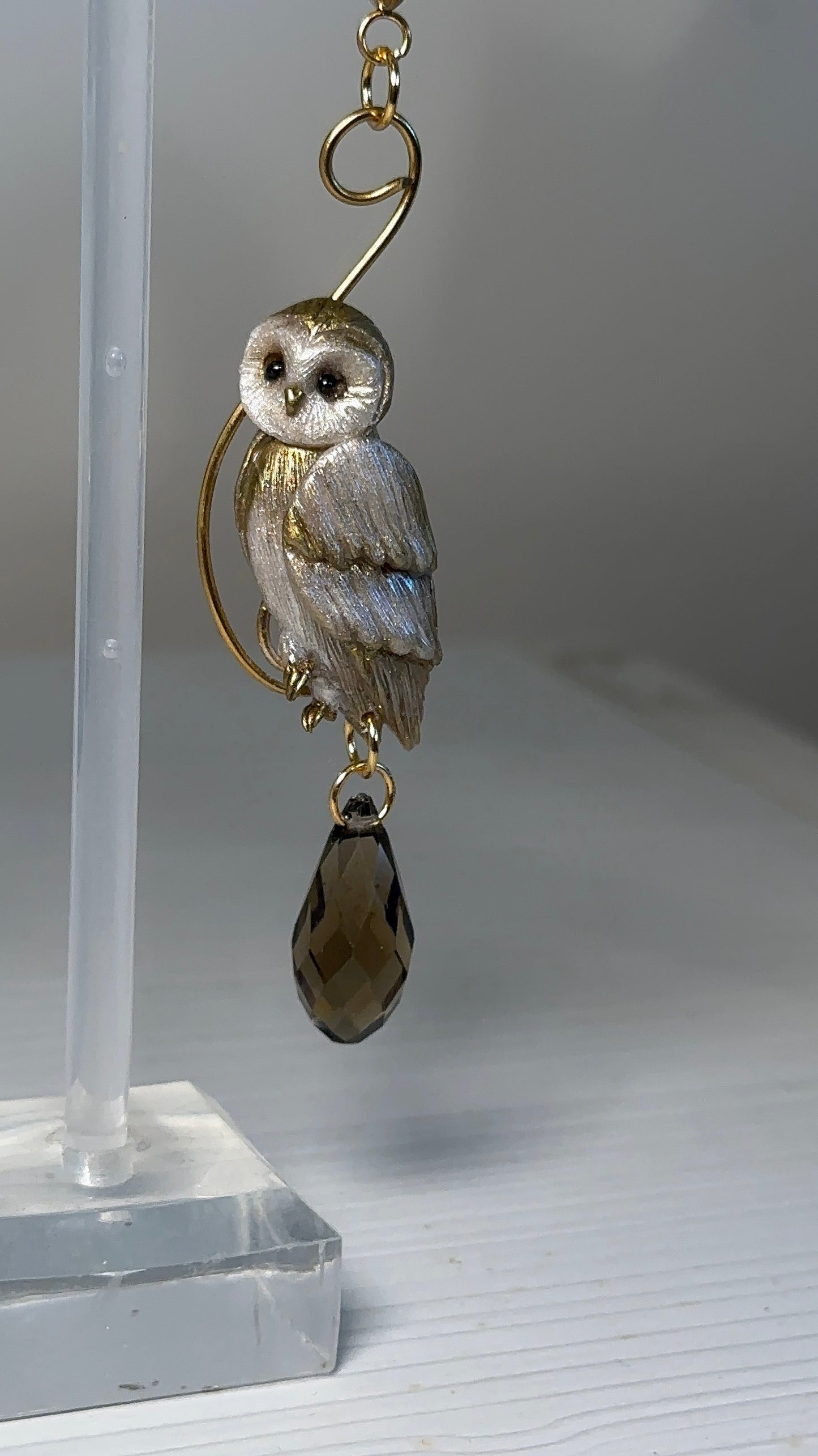 Handcrafted asymmetrical earrings with owl and leaf details, natural pearls, and smoky crystal drop — refined and timeless.