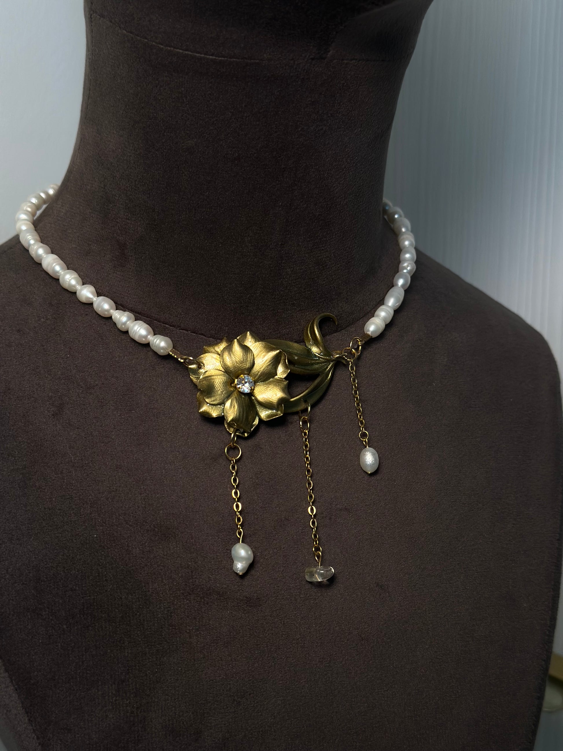 Pearl choker necklace with handcrafted gold flower centerpiece and cascading drops, unique statement jewelry for special occasions