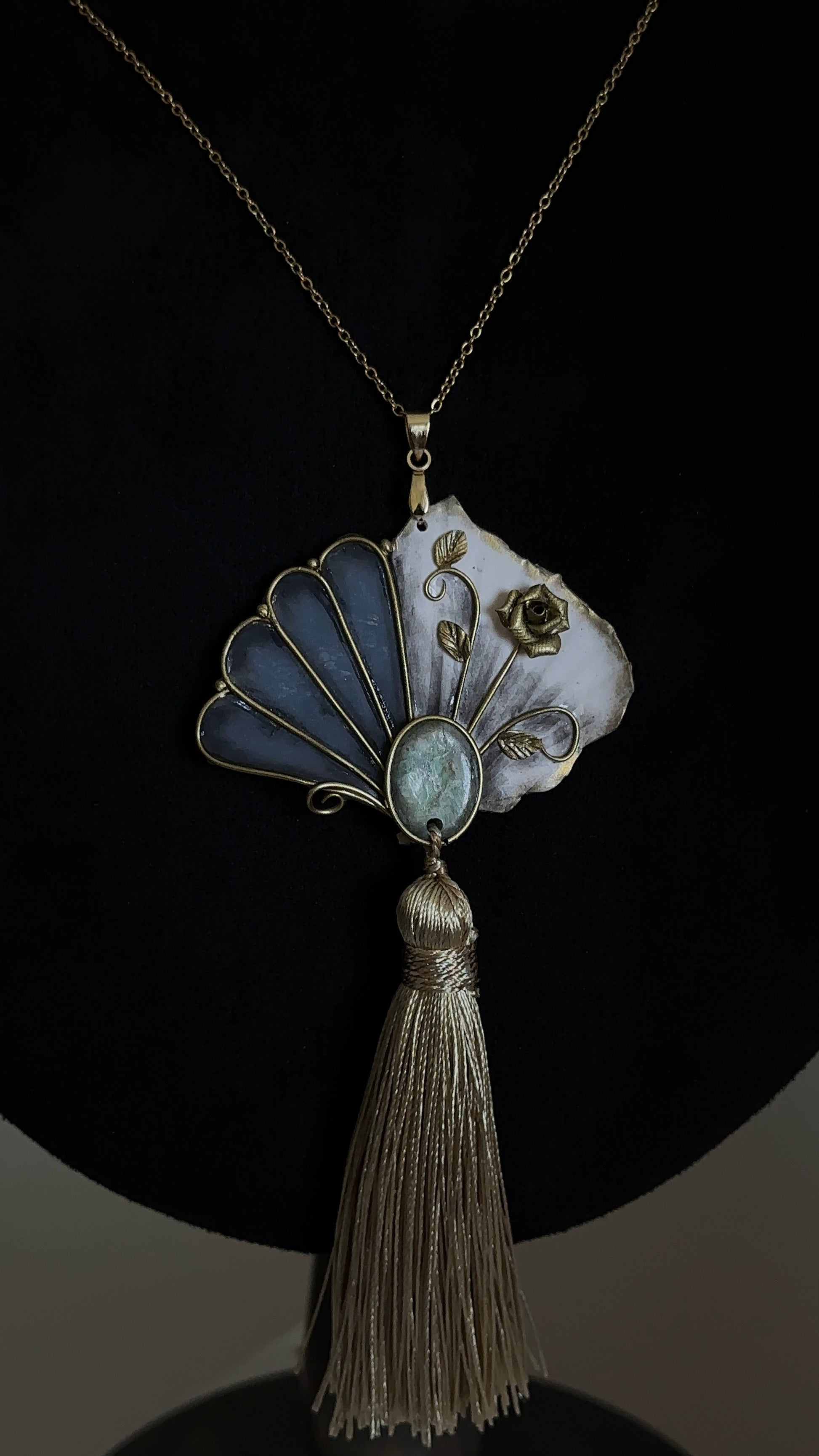     One-of-a-kind fan tassel necklace with handmade sculptural pendant, green accent and antique gold tones, statement jewelry for refined personal style.