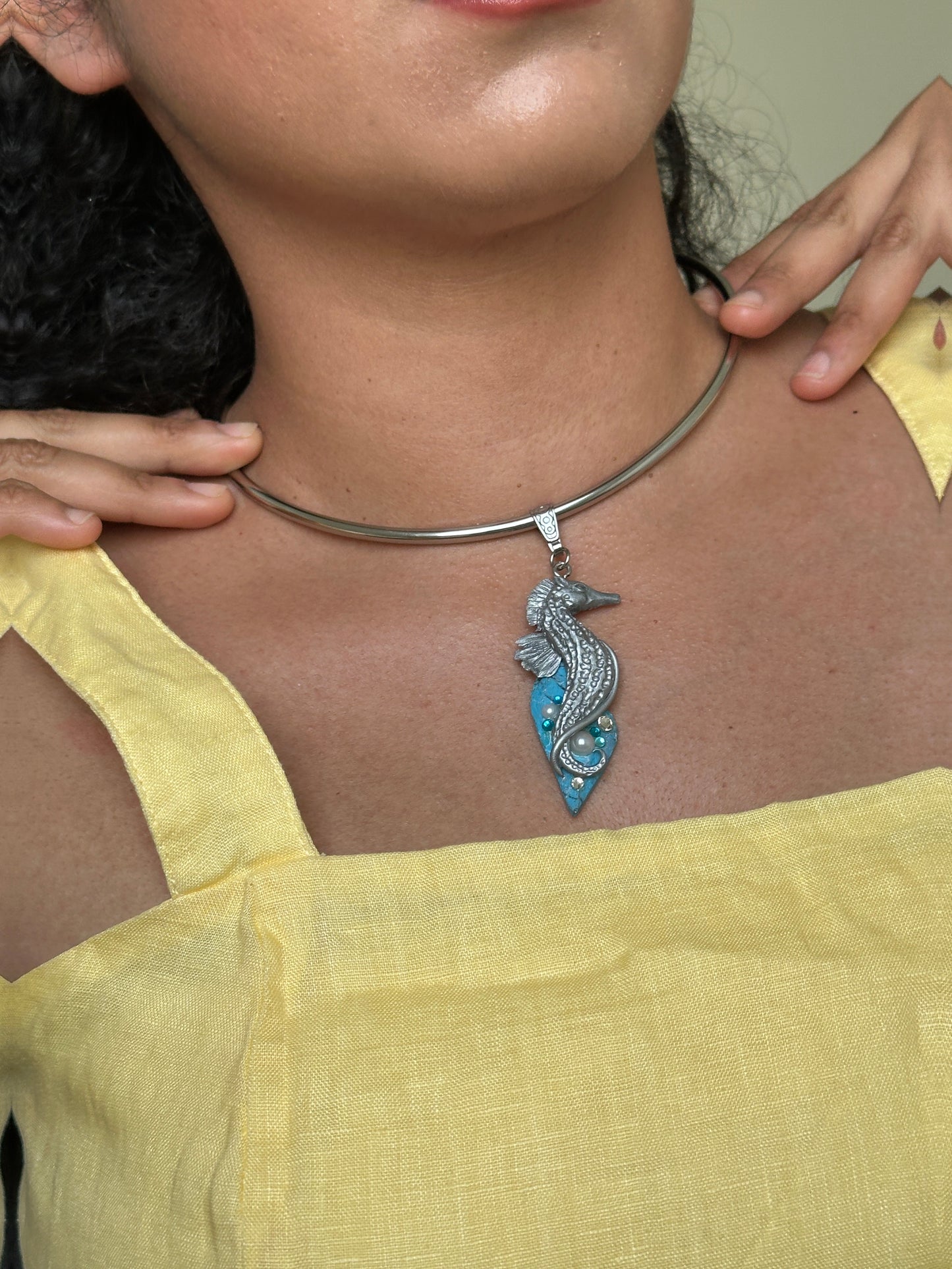     Handmade sculptural seahorse necklace on faux turquoise, a distinctive ocean inspired accessory for women who love rare jewelry.