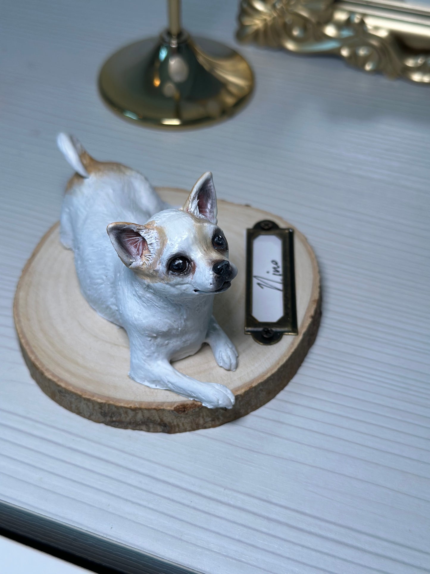 Handmade Chihuahua porcelain figurine, detailed custom pet sculpture for collectors, displayed on wooden round base with brass nameplate.