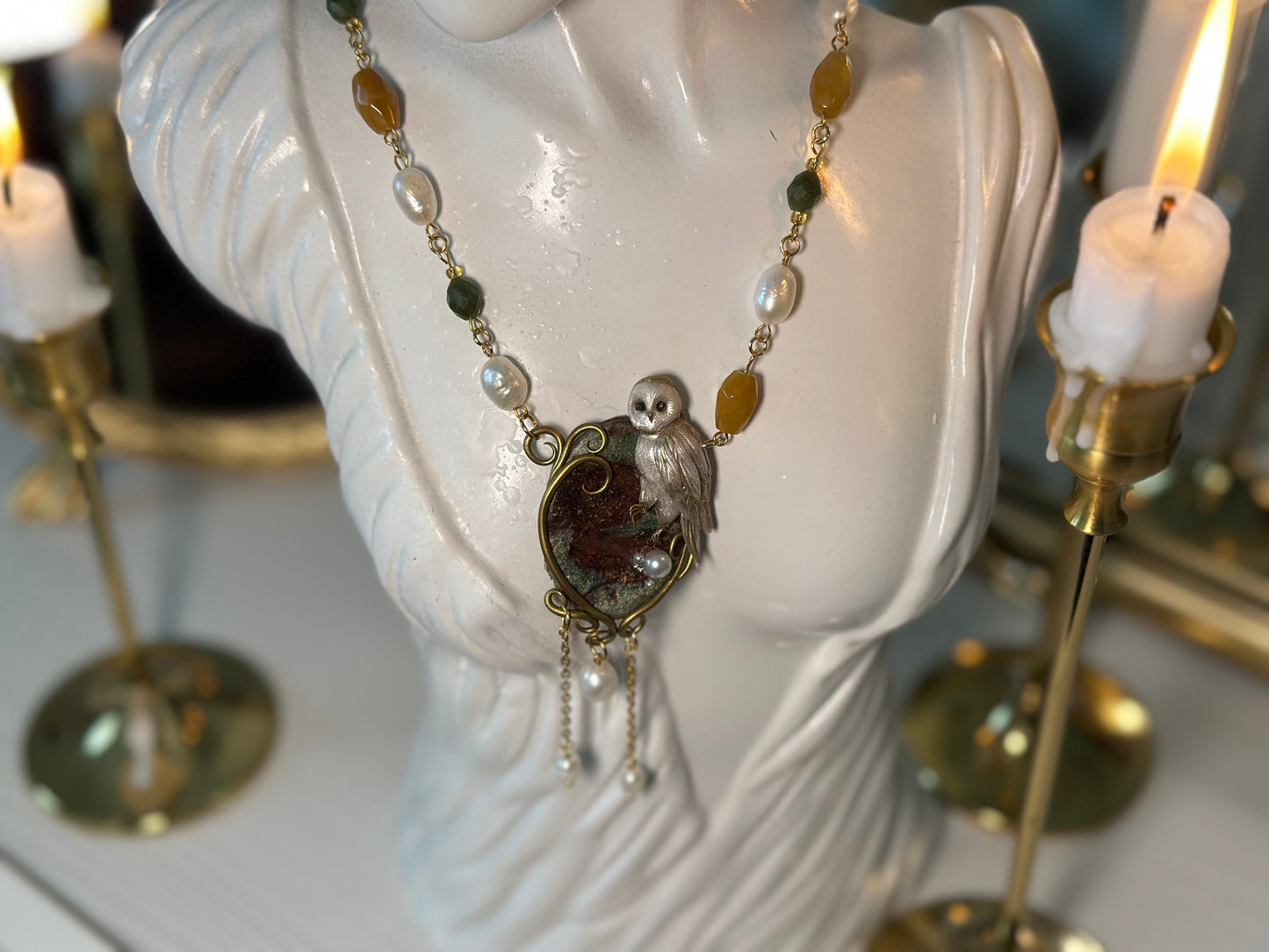 Luxury handcrafted necklace featuring a polymer clay owl on gemstone base, detailed with real pearls and gold stainless steel.