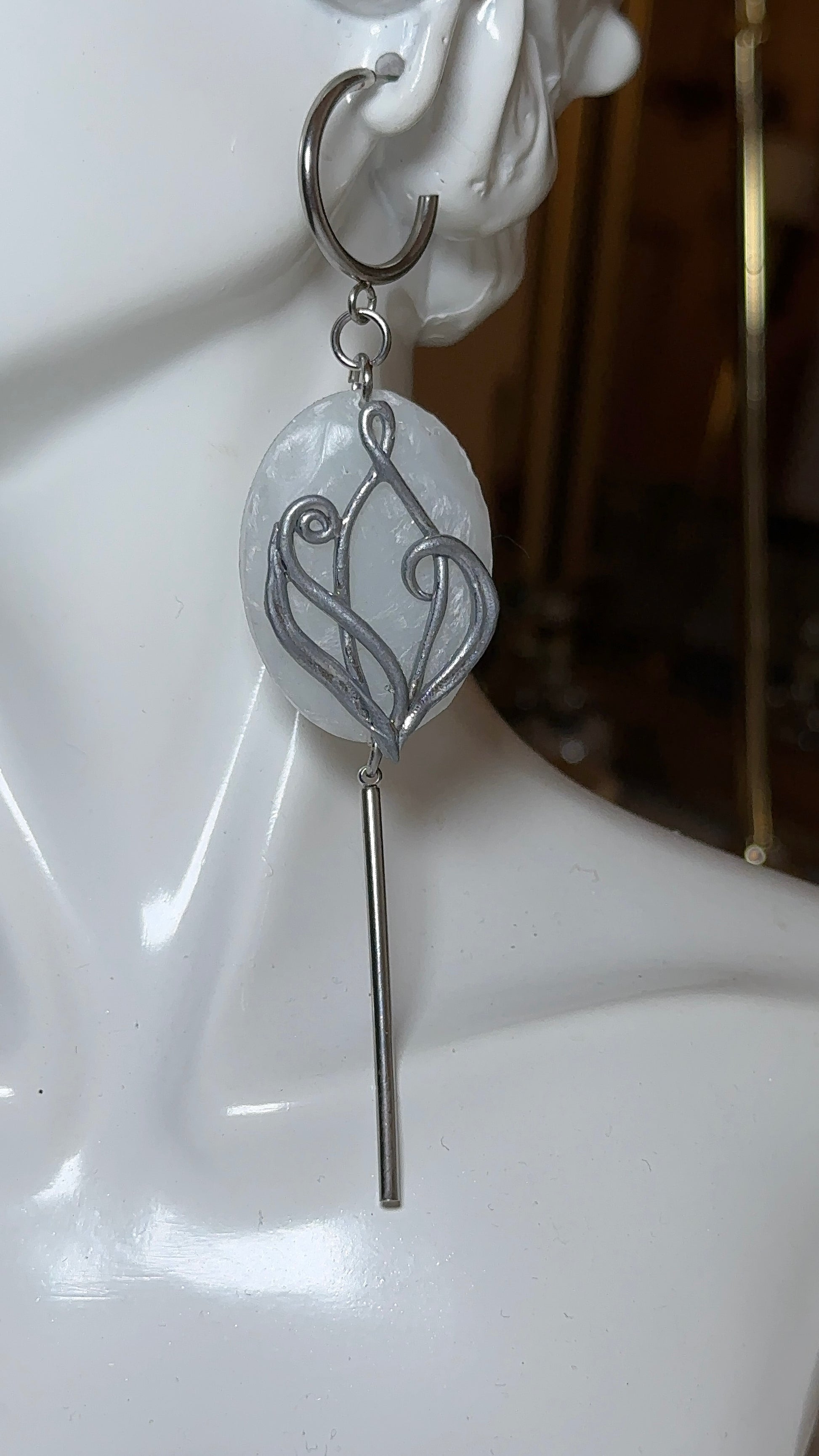 Minimalist silver earrings featuring translucent icy stone effect and elongated silhouette, refined contemporary jewelry for evening wear