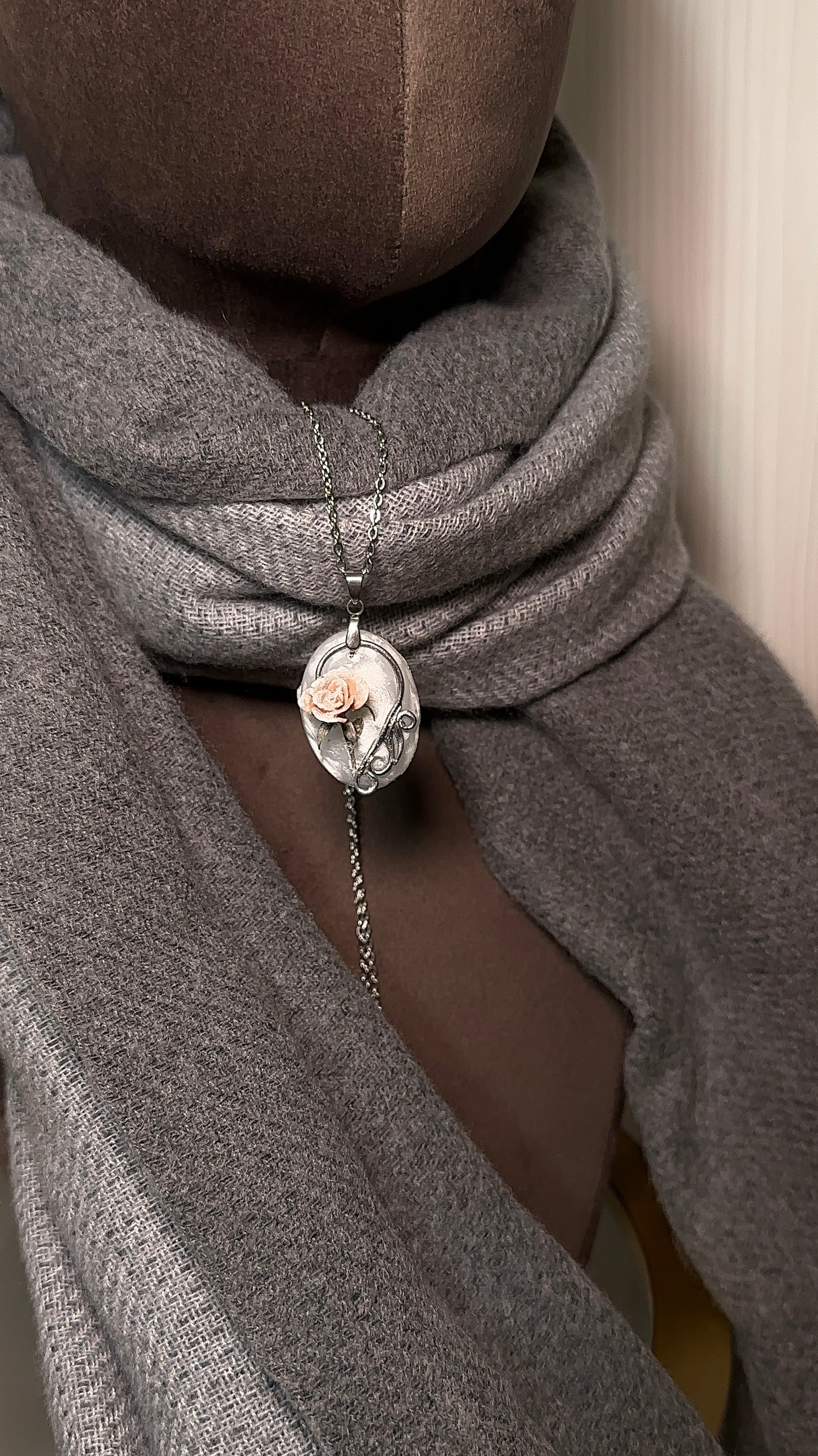 Close up of blush pink ice rose pendant on frosted resin base, artistic necklace for fashion collectors and influencers