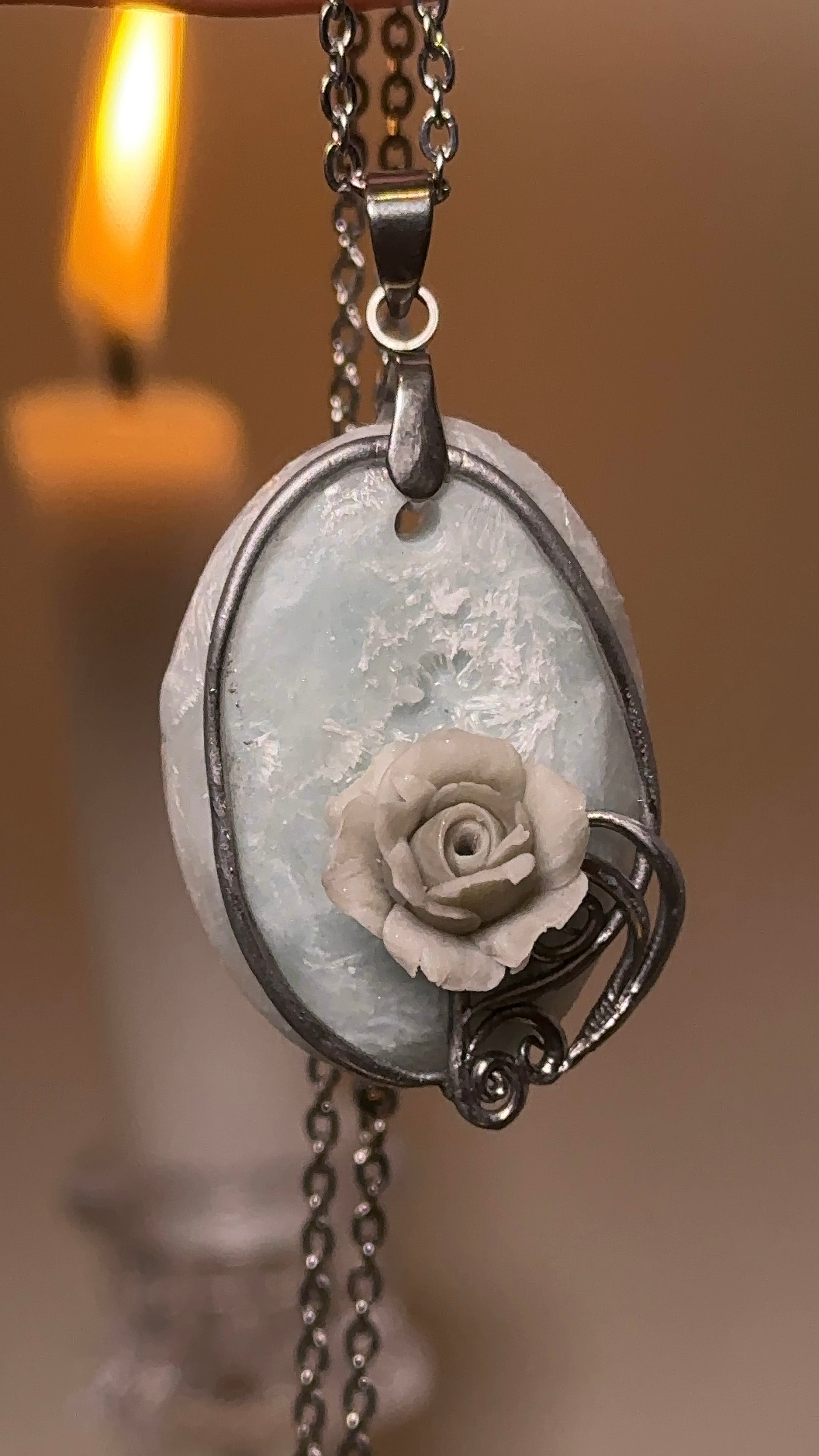 Sculpted ice rose pendant necklace in cold silver tones, distinctive collector jewelry for lovers of unique accessories