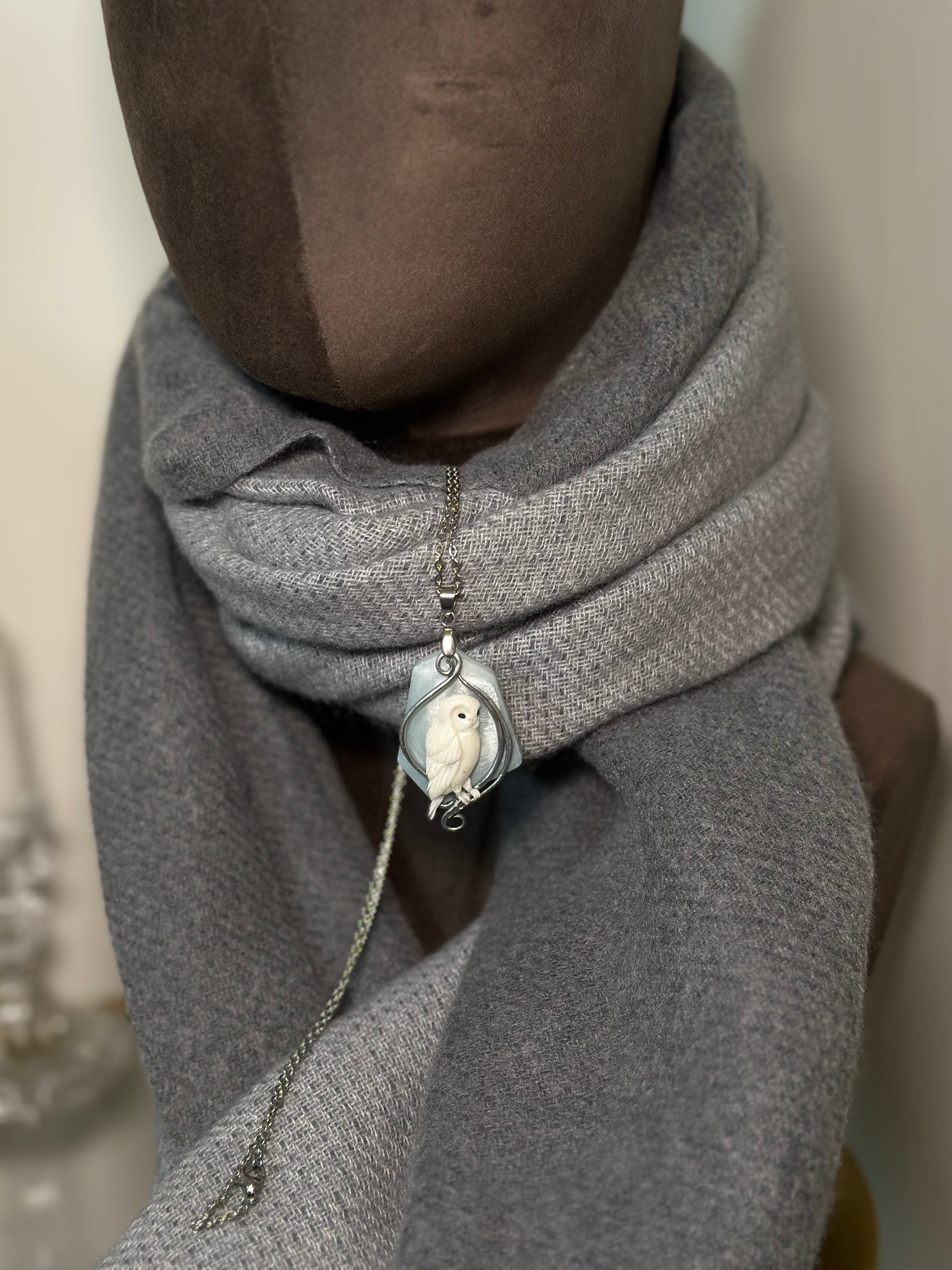 Close view of frosted winter owl pendant necklace, unique artistic accessory for fashion lovers who collect rare jewelry