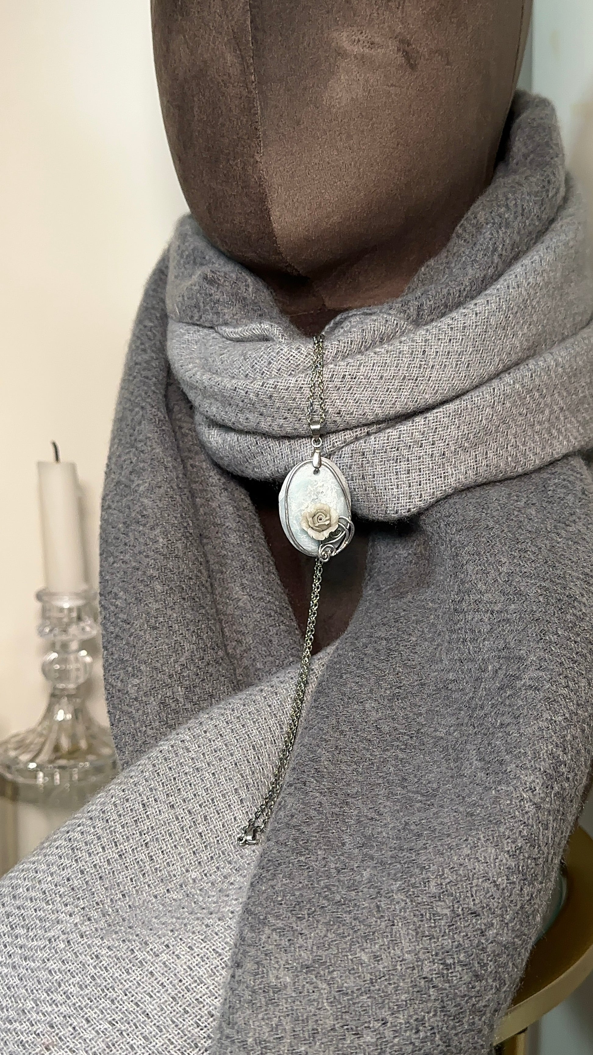 Close up of sculpted rose pendant on fractured frost resin base, artistic necklace for luxury fashion lovers and influencers